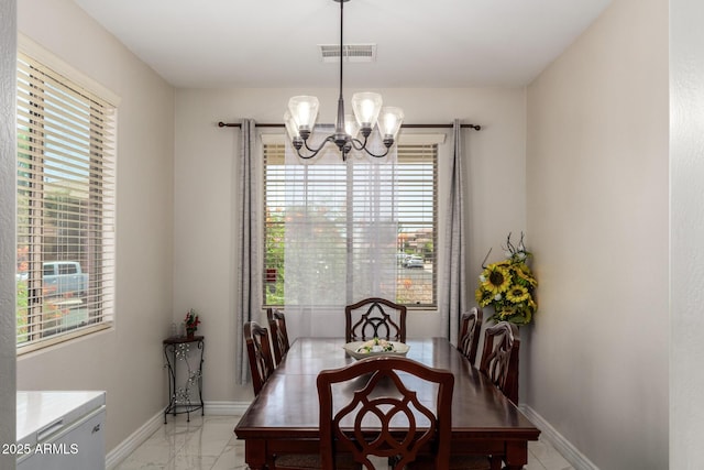 205 N 107th Dr, Avondale, AZ 85323 - dining room featuring a chandelier and light marble finish floors
