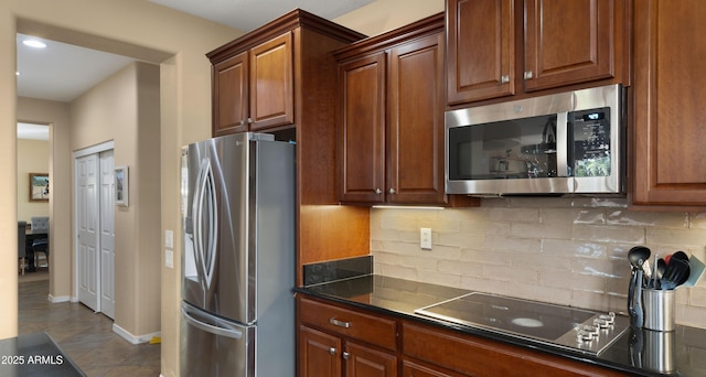 kitchen featuring backsplash, dark countertops, appliances with stainless steel finishes, baseboards, and recessed lighting