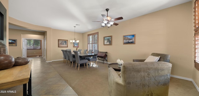 tiled dining room featuring baseboards, ceiling fan with notable chandelier, and carpet flooring