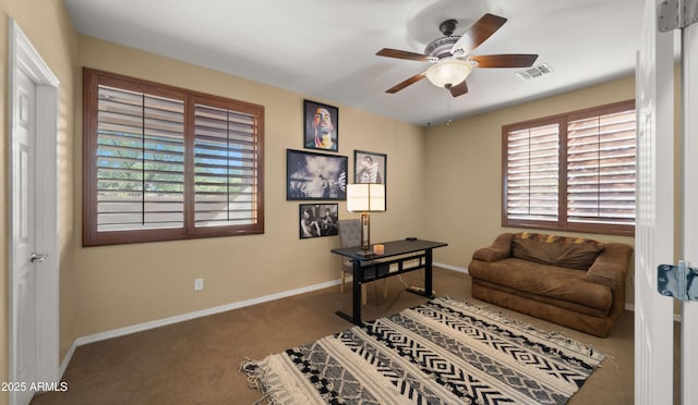 office with visible vents, carpet flooring, baseboards, and a ceiling fan