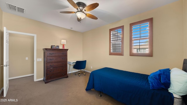 carpeted bedroom with visible vents, baseboards, and ceiling fan