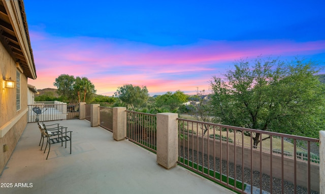 view of balcony at dusk