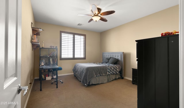 carpeted bedroom featuring ceiling fan, visible vents, and baseboards