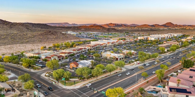 aerial view at dusk featuring a mountain view