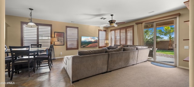 tiled living room featuring baseboards, ceiling fan, and visible vents