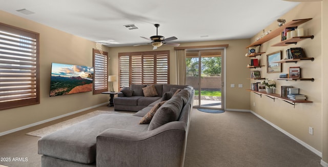 living room with carpet floors, ceiling fan, visible vents, and baseboards