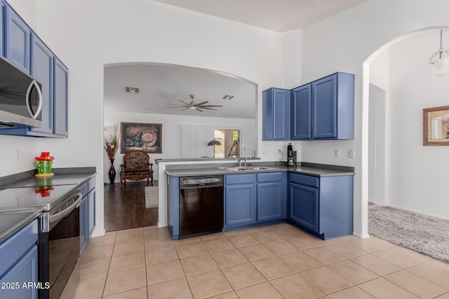 kitchen with dark countertops, blue cabinetry, and appliances with stainless steel finishes