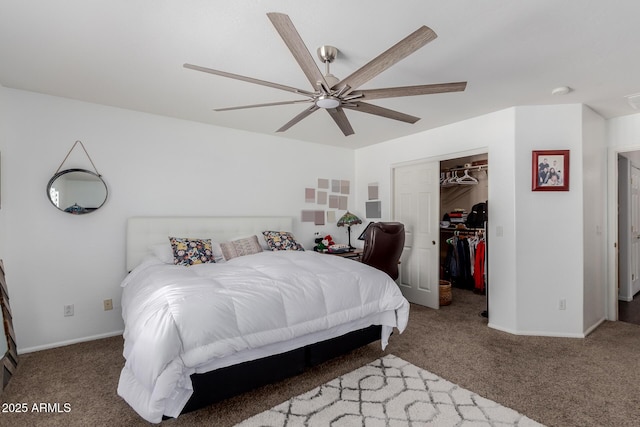 bedroom featuring a closet, carpet flooring, a walk in closet, and baseboards