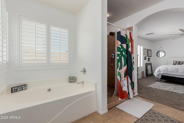 full bath featuring curtained shower, ceiling fan, a garden tub, ensuite bathroom, and tile patterned floors