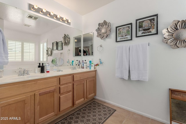 full bath featuring baseboards, visible vents, double vanity, a sink, and tile patterned flooring