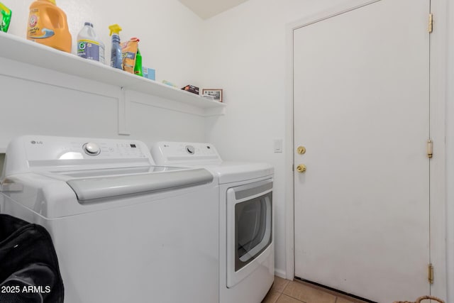 laundry room with light tile patterned floors, laundry area, and washer and clothes dryer