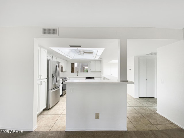 kitchen with white cabinetry, a tray ceiling, visible vents, and appliances with stainless steel finishes