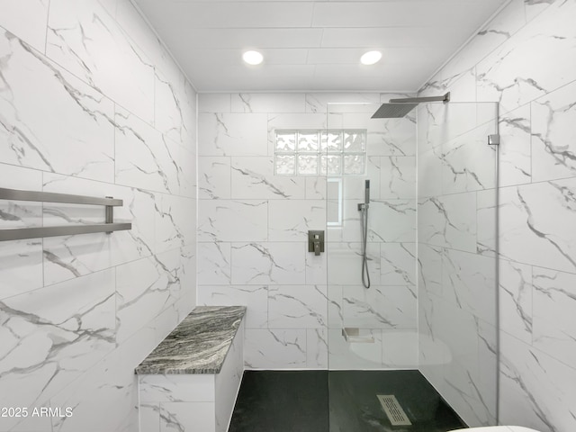 bathroom featuring a marble finish shower and recessed lighting
