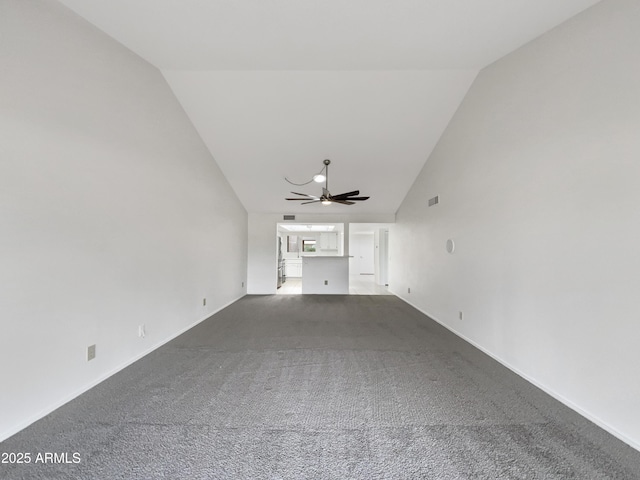 empty room featuring lofted ceiling, baseboards, visible vents, ceiling fan, and carpet