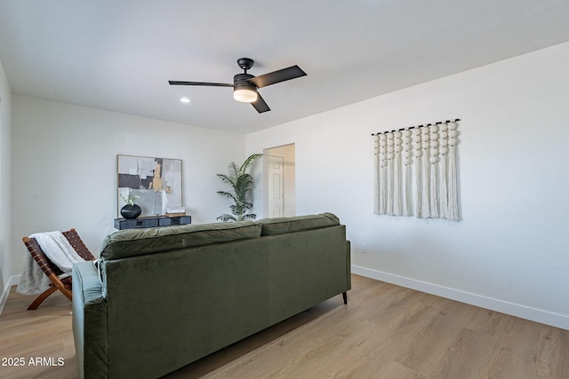 living room with light hardwood / wood-style flooring and ceiling fan