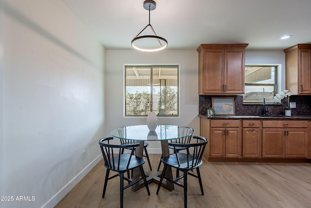 dining room featuring sink and light wood-type flooring