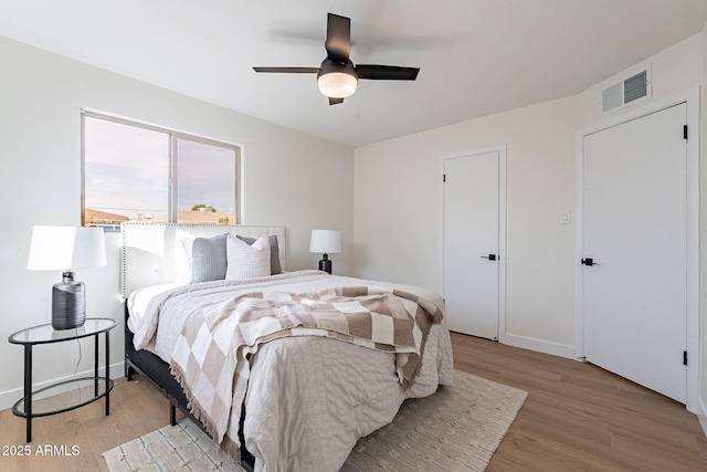 bedroom with ceiling fan and light hardwood / wood-style flooring