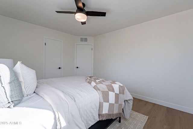 bedroom with hardwood / wood-style flooring and ceiling fan