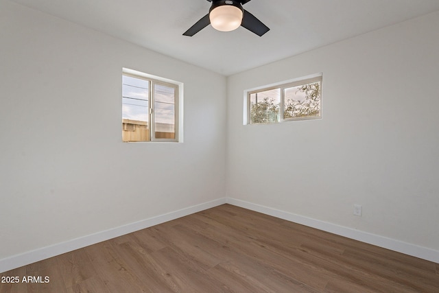 unfurnished room with hardwood / wood-style floors and ceiling fan