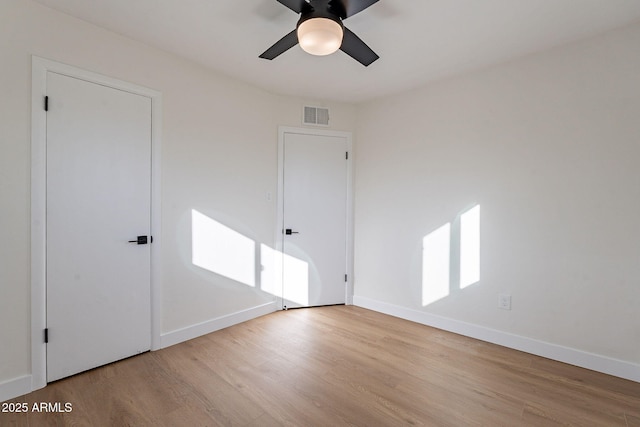 unfurnished room featuring ceiling fan and light wood-type flooring