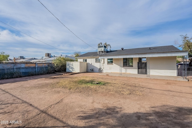 rear view of house featuring cooling unit