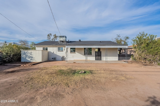 back of house with a patio area, a shed, and central air condition unit