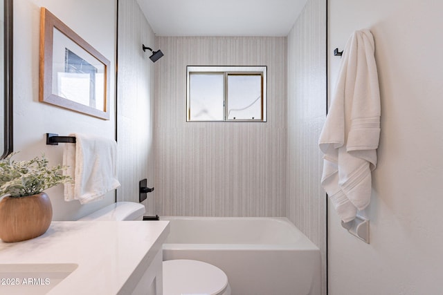 full bathroom with vanity, tiled shower / bath, a wealth of natural light, and toilet