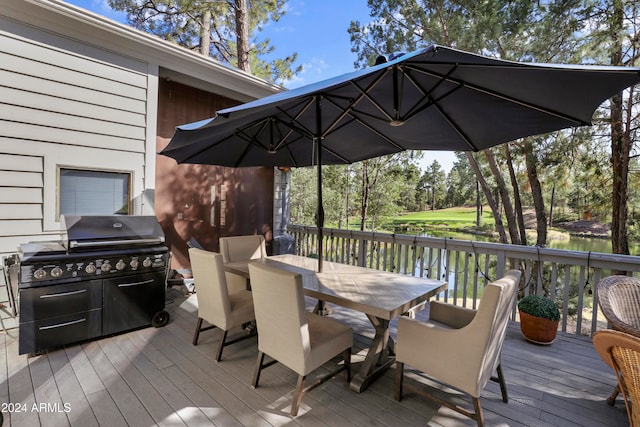 deck with a water view and grilling area