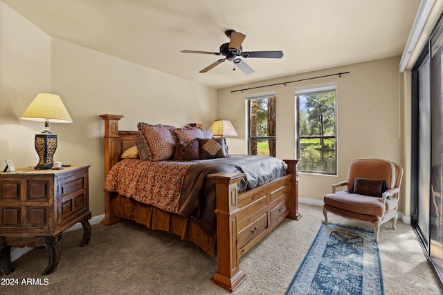 carpeted bedroom with ceiling fan and a closet