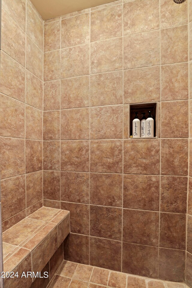 bathroom with a tile shower