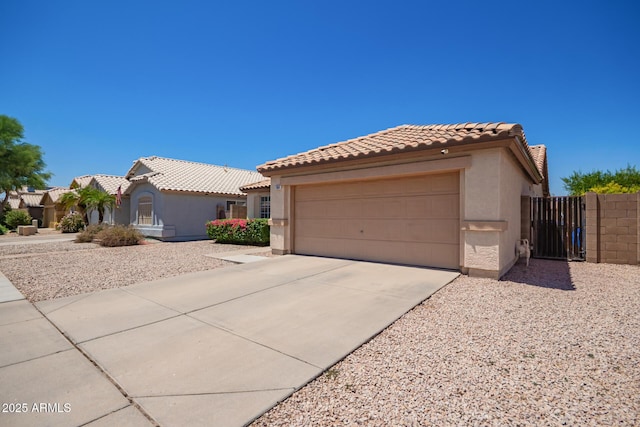 764 E Shannon St, Chandler, AZ 85225 - mediterranean / spanish-style house featuring stucco siding, a tiled roof, driveway, a garage, and a gate