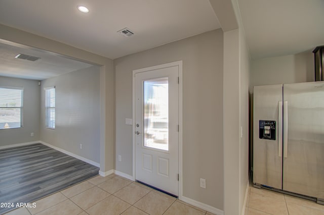 entryway featuring light tile patterned floors, baseboards, visible vents, and recessed lighting