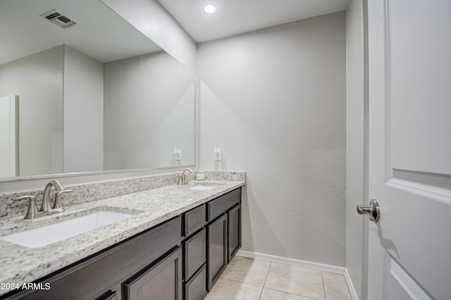 full bath featuring baseboards, a sink, visible vents, and tile patterned floors