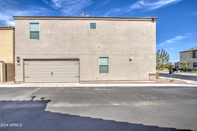 view of property exterior with a garage and stucco siding