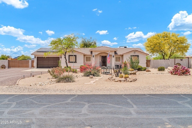 37508 N 12th St, Phoenix, AZ 85086 - view of front of home with stucco siding, an attached garage, a tiled roof, driveway, and roof mounted solar panels