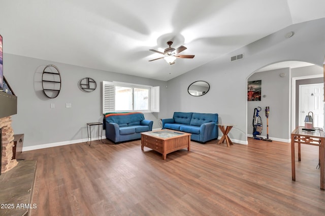 37508 N 12th St, Phoenix, AZ 85086 - living room featuring arched walkways, ceiling fan, wood finished floors, and baseboards