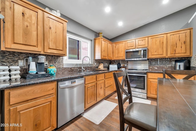 37508 N 12th St, Phoenix, AZ 85086 - kitchen featuring stainless steel appliances, a sink, vaulted ceiling, wood finished floors, and backsplash