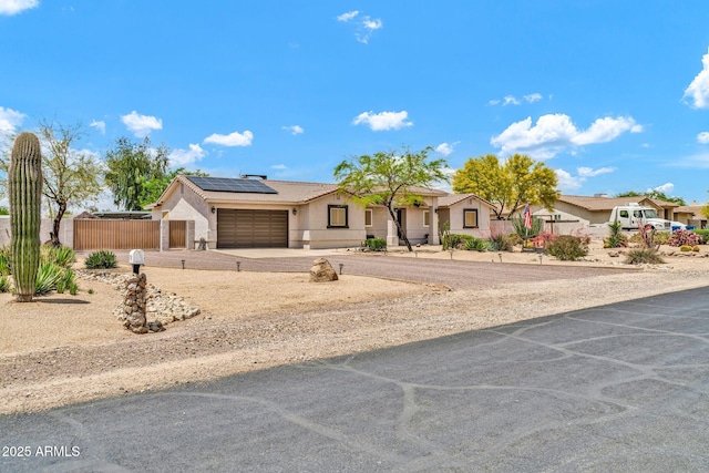 37508 N 12th St, Phoenix, AZ 85086 - ranch-style house featuring an attached garage, stucco siding, roof mounted solar panels, concrete driveway, and a residential view