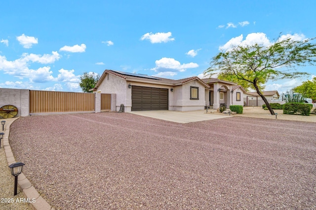 37508 N 12th St, Phoenix, AZ 85086 - ranch-style house with a gate, stucco siding, an attached garage, solar panels, and driveway