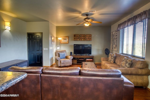 living room featuring ceiling fan and hardwood / wood-style floors