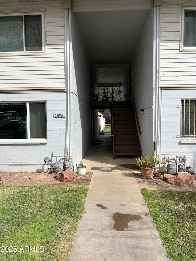 view of exterior entry featuring brick siding