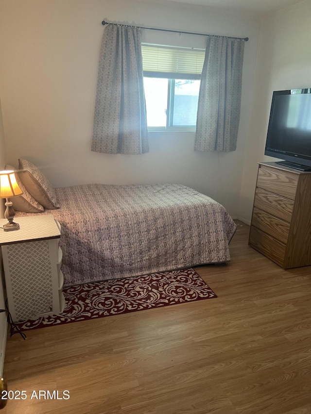 bedroom featuring wood finished floors