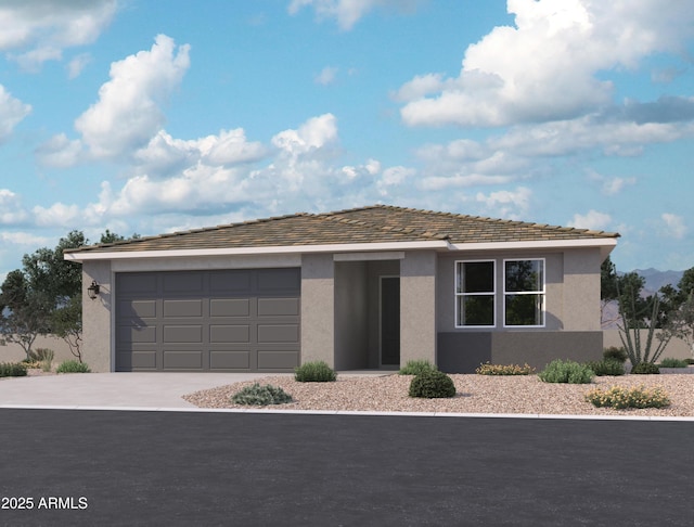 view of front of property with concrete driveway, stucco siding, and an attached garage
