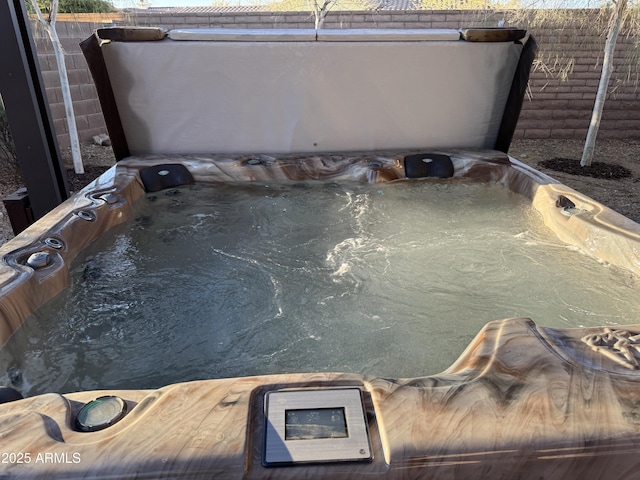 view of swimming pool with a hot tub