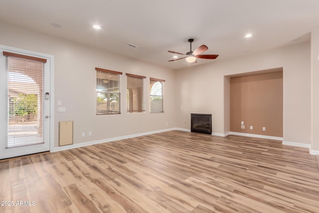 unfurnished living room with ceiling fan and light hardwood / wood-style flooring