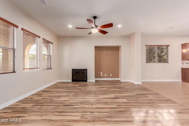 unfurnished living room featuring ceiling fan and light hardwood / wood-style floors