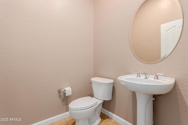 bathroom with tile patterned floors and toilet