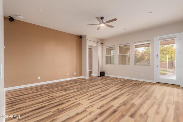 spare room with light hardwood / wood-style flooring and ceiling fan