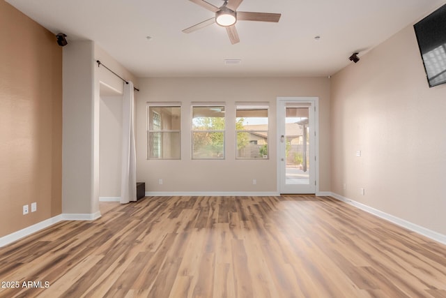 unfurnished room with ceiling fan and light hardwood / wood-style flooring