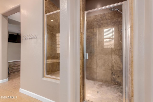 bathroom with tile patterned flooring and a shower with shower door